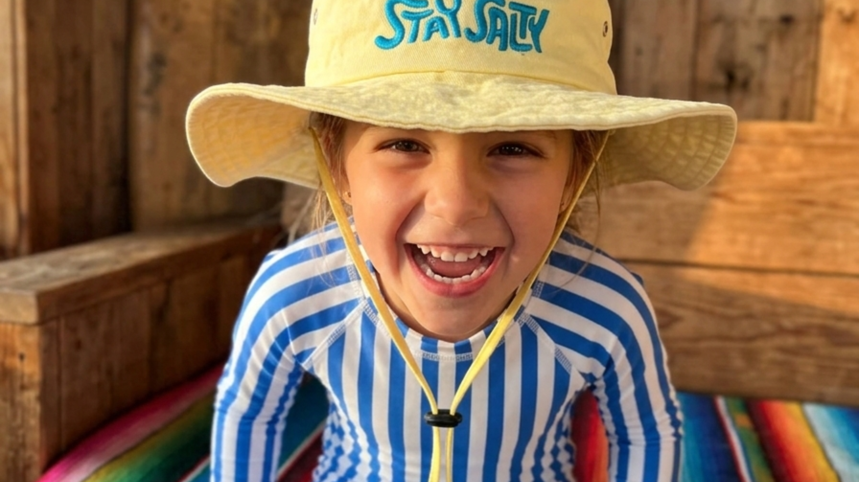 Toddler wearing a little boonie hat for sunny beach adventures