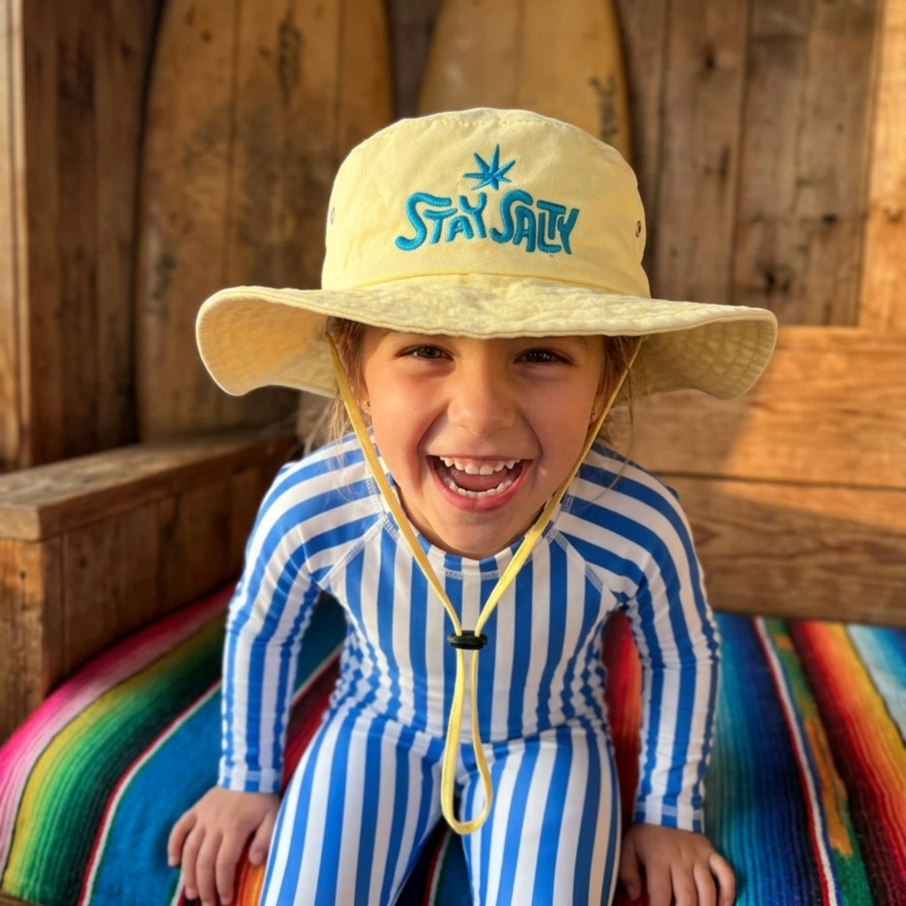Toddler wearing a little boonie hat for sunny beach adventures